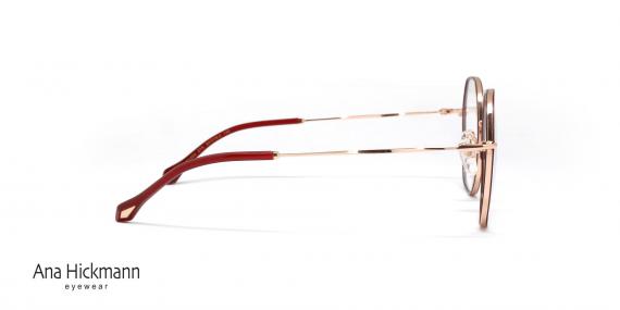 عینک طبی زنانه چندضلعی آناهیکمن با بدنه طلایی و حدقه دور قرمز - نیم‌رخ