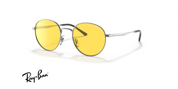 عینک آفتابی ری بن فریم فلزی گرد نقره ای براق و عدسی زرد فتوکرومیک - عکس از زاویه سه رخ