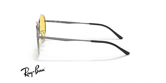 عینک آفتابی ری بن فریم فلزی گرد نقره ای براق و عدسی زرد فتوکرومیک - عکس از زاویه کنار
